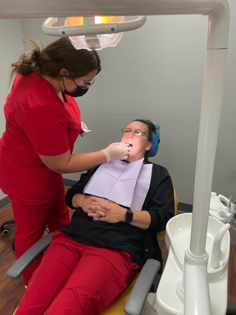 Dental assistant working in a patient's mouth