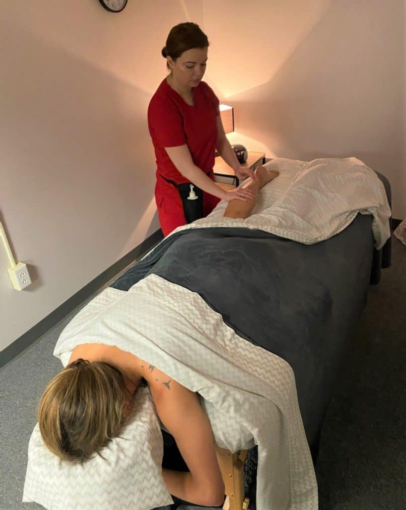 massage therapist giving a massage to a woman