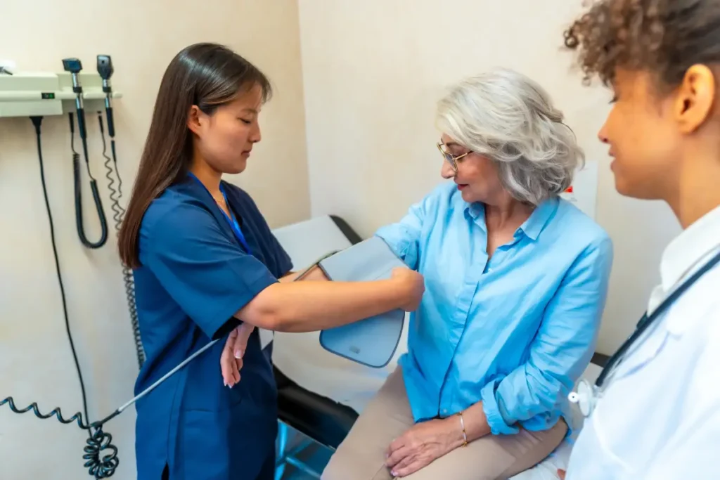 Medical assistant taking a patient’s blood pressure.